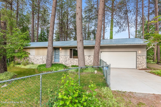 15248 N Atlas Rd, Rathdrum, ID 83858 - view of front of property featuring stone siding, driveway, and metal roof