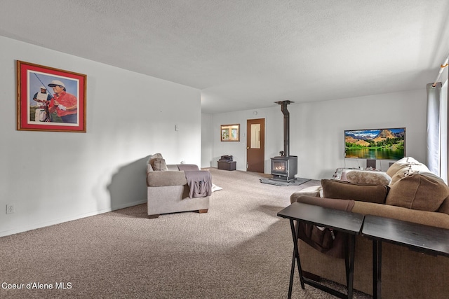 15248 N Atlas Rd, Rathdrum, ID 83858 - carpeted living area featuring a wood stove and a textured ceiling