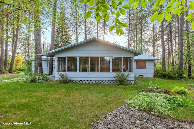 15248 N Atlas Rd, Rathdrum, ID 83858 - view of front of house with a sunroom, a front yard, and crawl space