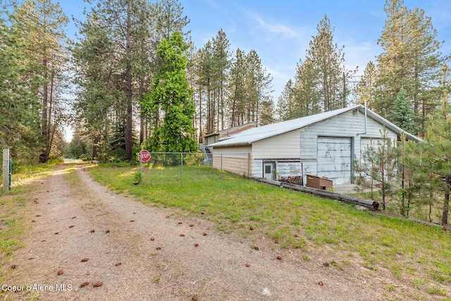 15248 N Atlas Rd, Rathdrum, ID 83858 - view of home's exterior featuring driveway, a garage, and an outdoor structure