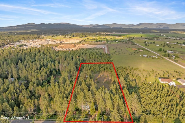 15248 N Atlas Rd, Rathdrum, ID 83858 - aerial overview of property's location with mountains, property parcel outlined, and a heavily wooded area