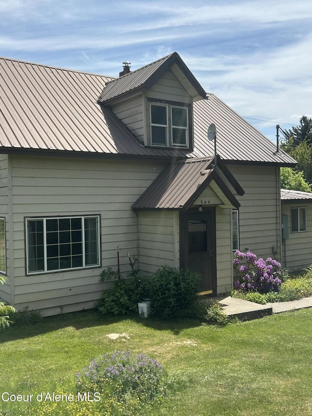 344 N 20th St, Saint Maries, ID 83861 - rear view of property with a lawn and metal roof