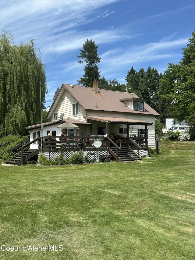 344 N 20th St, Saint Maries, ID 83861 - rear view of property featuring stairs, a wooden deck, and a lawn