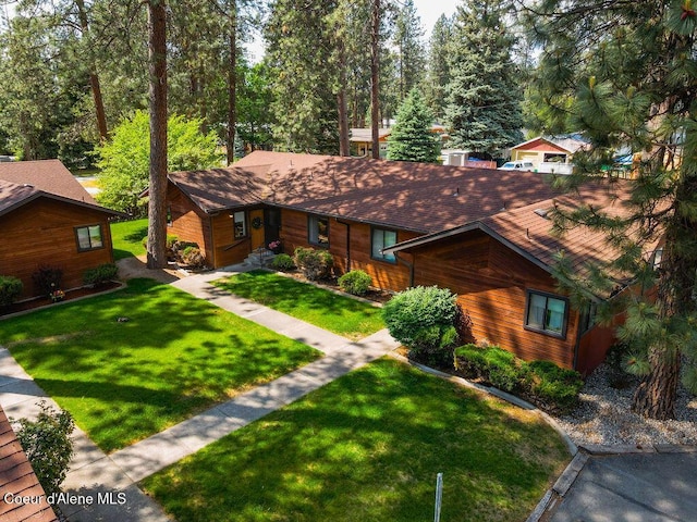1130 E Timber Ln # 2, Coeur Dalene, ID 83815 - chalet / cabin featuring a front yard and roof with shingles
