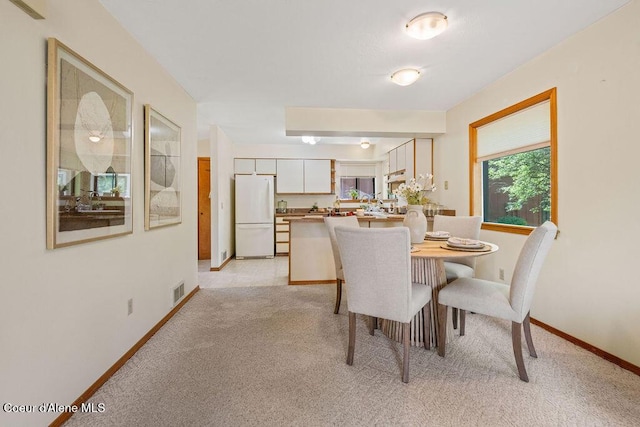 1130 E Timber Ln # 2, Coeur Dalene, ID 83815 - dining space with light colored carpet and baseboards
