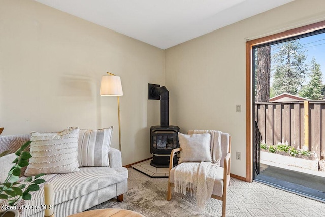 1130 E Timber Ln # 2, Coeur Dalene, ID 83815 - carpeted living room with a wood stove and baseboards