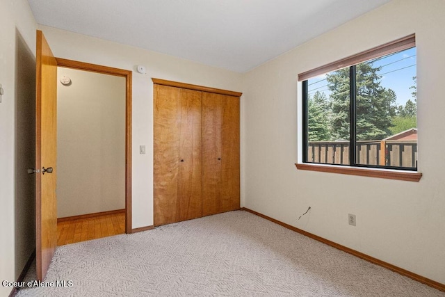 1130 E Timber Ln # 2, Coeur Dalene, ID 83815 - unfurnished bedroom featuring baseboards, carpet flooring, and a closet