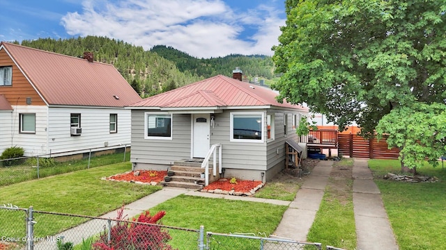 316 W Brown Ave, Kellogg, ID 83837 - view of front of property with metal roof, a chimney, cooling unit, and a wooded view