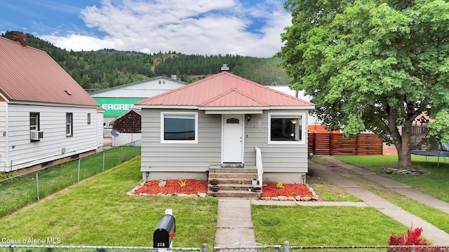 316 W Brown Ave, Kellogg, ID 83837 - view of front facade featuring metal roof, entry steps, a forest view, and a trampoline