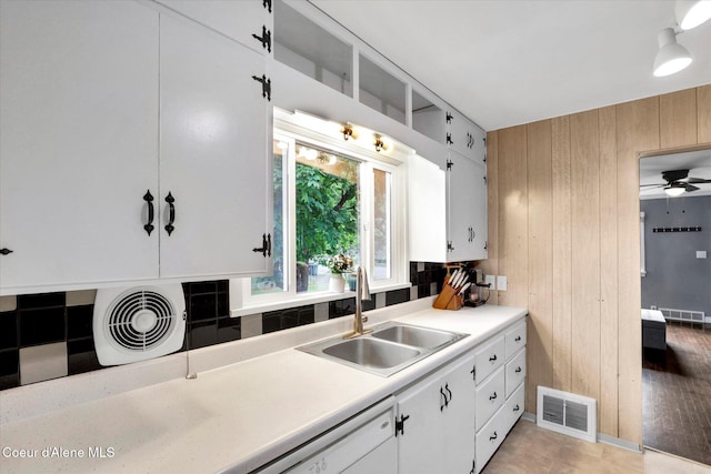 316 W Brown Ave, Kellogg, ID 83837 - kitchen featuring a sink, tasteful backsplash, wooden walls, light countertops, and white dishwasher