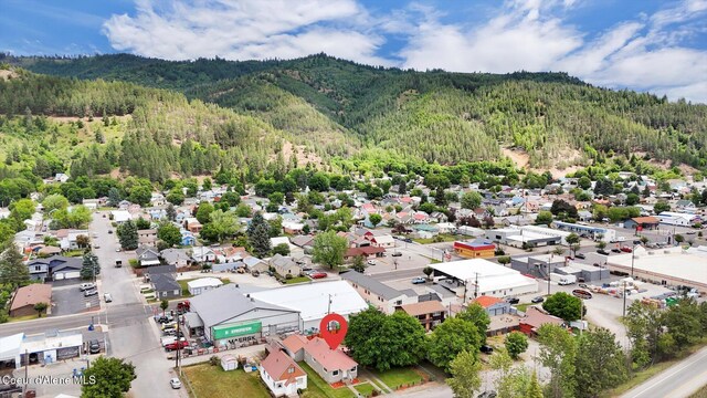 316 W Brown Ave, Kellogg, ID 83837 - aerial view of residential area with a heavily wooded area and a mountain backdrop