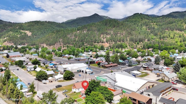 316 W Brown Ave, Kellogg, ID 83837 - aerial perspective of suburban area with a heavily wooded area and a mountain backdrop