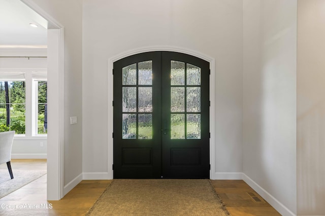 287 Mesa Dr, Athol, ID 83801 - foyer entrance featuring french doors, arched walkways, wood finished floors, and recessed lighting