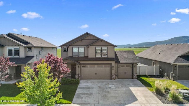 13121 N Loveland Way, Hayden, ID 83835 - view of front of property with driveway, a mountain view, and an attached garage