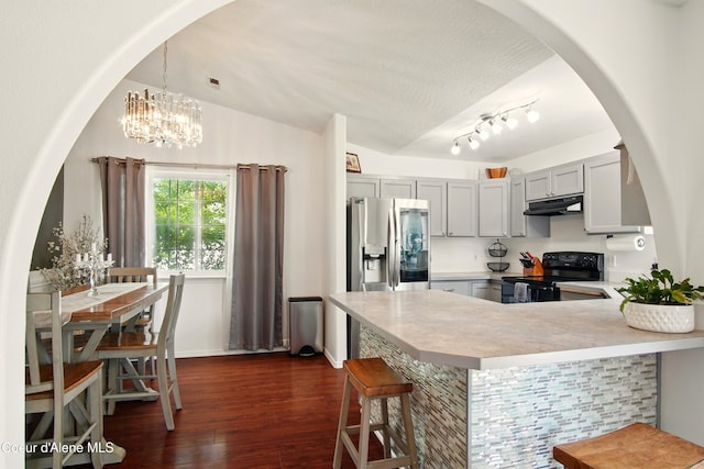 500 N Elm Rd, Post Falls, ID 83854 - kitchen featuring black electric range oven, under cabinet range hood, a peninsula, dark wood finished floors, and light countertops
