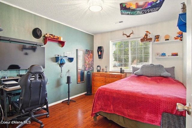 500 N Elm Rd, Post Falls, ID 83854 - bedroom featuring wood finished floors, a desk, a textured ceiling, and baseboards