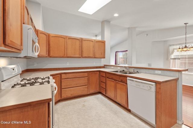 175 E Jeffrey Pine Ln, Coeur Dalene, ID 83815 - kitchen featuring white appliances, a sink, a peninsula, light countertops, and vaulted ceiling