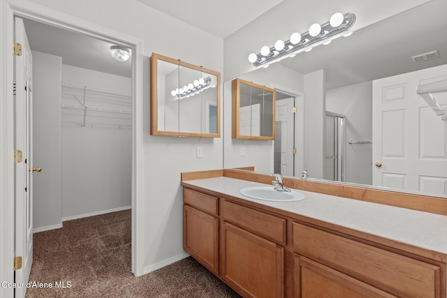 175 E Jeffrey Pine Ln, Coeur Dalene, ID 83815 - full bath featuring vanity, a spacious closet, a shower with door, and baseboards