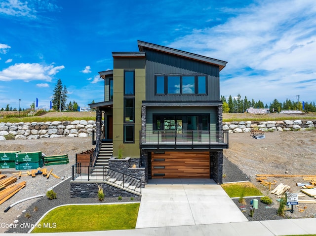 2671 W Lumber Ln, Coeur Dalene, ID 83814 - contemporary house featuring an attached garage, driveway, and stairway