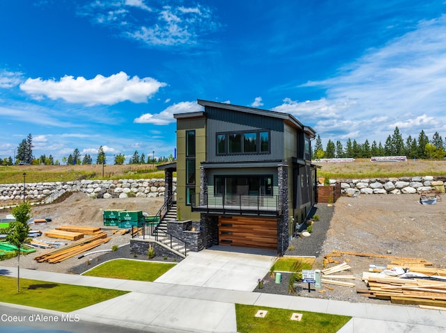 2671 W Lumber Ln, Coeur Dalene, ID 83814 - contemporary home with stairway, driveway, and an attached garage