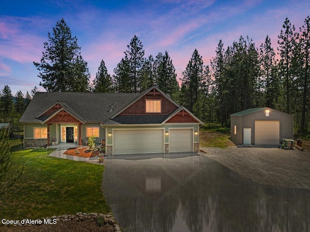 23378 N Prominence Rd, Rathdrum, ID 83858 - craftsman house with asphalt driveway, stone siding, a yard, and an outbuilding