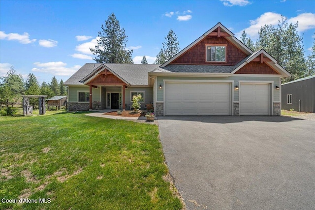 23378 N Prominence Rd, Rathdrum, ID 83858 - craftsman-style home with driveway, stone siding, a garage, and a front lawn