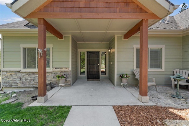 23378 N Prominence Rd, Rathdrum, ID 83858 - entrance to property with a patio and roof with shingles