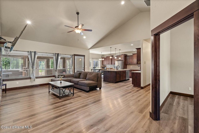 23378 N Prominence Rd, Rathdrum, ID 83858 - living area with ceiling fan, light wood finished floors, high vaulted ceiling, recessed lighting, and a chandelier