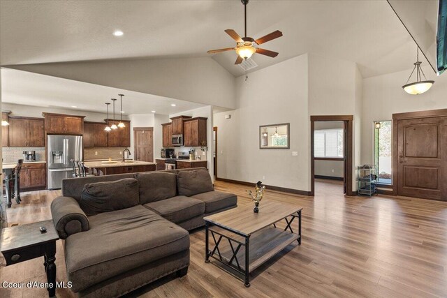 23378 N Prominence Rd, Rathdrum, ID 83858 - living area with high vaulted ceiling, light wood finished floors, ceiling fan, and recessed lighting