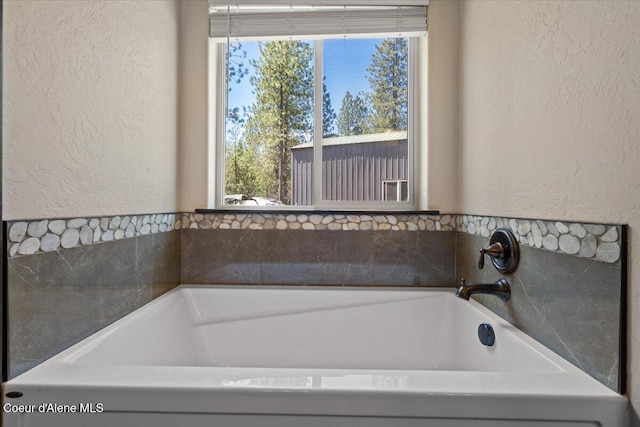 23378 N Prominence Rd, Rathdrum, ID 83858 - bathroom featuring a textured wall and a bath