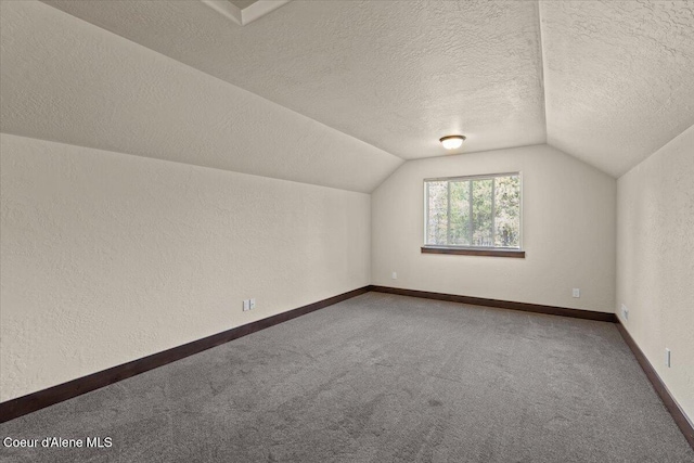 23378 N Prominence Rd, Rathdrum, ID 83858 - additional living space featuring vaulted ceiling, carpet flooring, a textured ceiling, and a textured wall