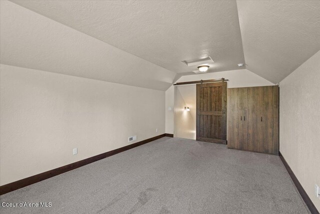 23378 N Prominence Rd, Rathdrum, ID 83858 - bonus room with vaulted ceiling, a textured ceiling, and carpet floors