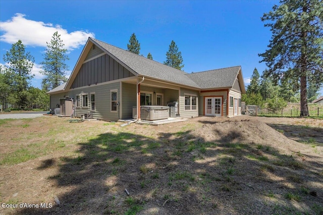 23378 N Prominence Rd, Rathdrum, ID 83858 - rear view of house featuring french doors, a hot tub, board and batten siding, and a shingled roof