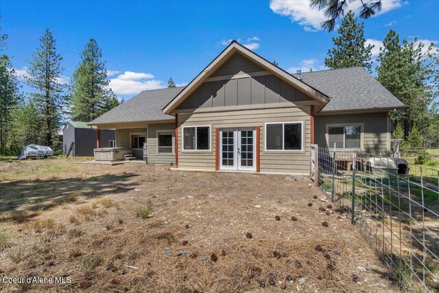 23378 N Prominence Rd, Rathdrum, ID 83858 - rear view of property with french doors, board and batten siding, and roof with shingles