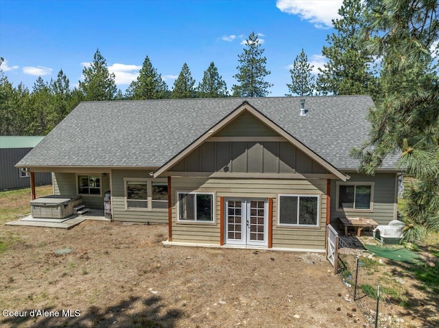 23378 N Prominence Rd, Rathdrum, ID 83858 - rear view of property with a hot tub, a shingled roof, board and batten siding, and french doors