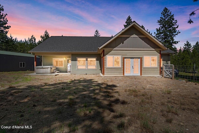 23378 N Prominence Rd, Rathdrum, ID 83858 - back of property at dusk featuring a hot tub and french doors