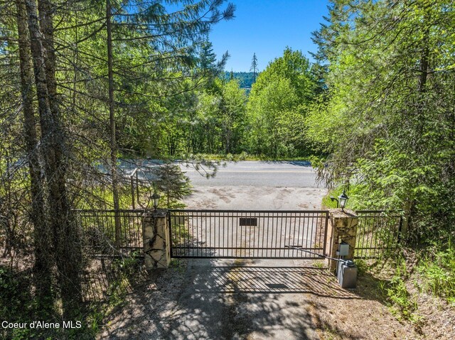 16529 N Triangle 7 Rd, Hayden, ID 83835 - gate featuring a view of trees