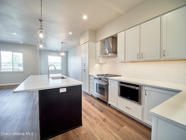 1048 E 4th Ave, Post Falls, ID 83854 - kitchen with a sink, wall chimney exhaust hood, high end stainless steel range, decorative backsplash, and white cabinetry