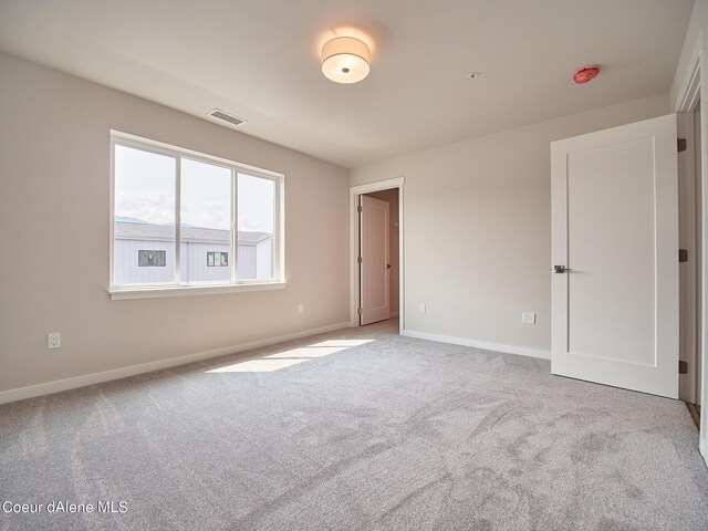 1048 E 4th Ave, Post Falls, ID 83854 - unfurnished room featuring baseboards, carpet floors, and a smoke detector