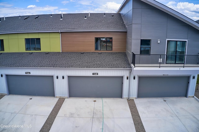 1048 E 4th Ave, Post Falls, ID 83854 - rear view of house with roof with shingles and a garage