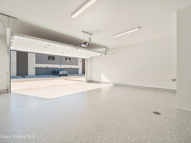 1048 E 4th Ave, Post Falls, ID 83854 - garage with baseboards and a garage door opener