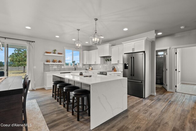 27455 N Caribou Ave, Athol, ID 83801 - kitchen with stainless steel appliances, healthy amount of natural light, a kitchen island, recessed lighting, and white cabinetry