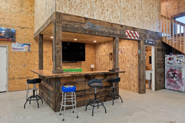 27455 N Caribou Ave, Athol, ID 83801 - indoor bar with a towering ceiling, concrete floors, and freestanding refrigerator