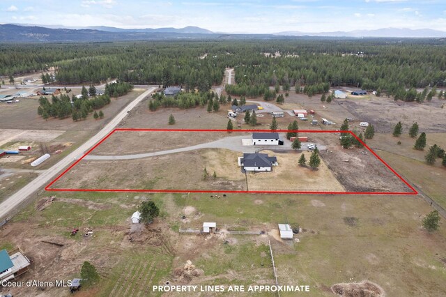 27455 N Caribou Ave, Athol, ID 83801 - aerial overview of property's location with a forest, mountains, and property boundaries highlighted