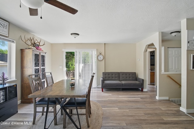 15272 N Stevens St, Rathdrum, ID 83858 - dining space with plenty of natural light, wood finished floors, ceiling fan, arched walkways, and a textured ceiling