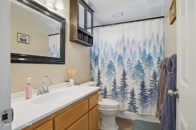 15272 N Stevens St, Rathdrum, ID 83858 - bathroom with toilet, vanity, curtained shower, and wood finished floors