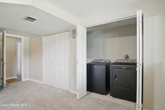 15272 N Stevens St, Rathdrum, ID 83858 - laundry room featuring washing machine and dryer, light carpet, and baseboards