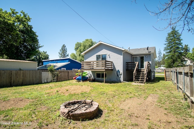 15272 N Stevens St, Rathdrum, ID 83858 - rear view of house featuring an outdoor fire pit, stairs, and a wooden deck