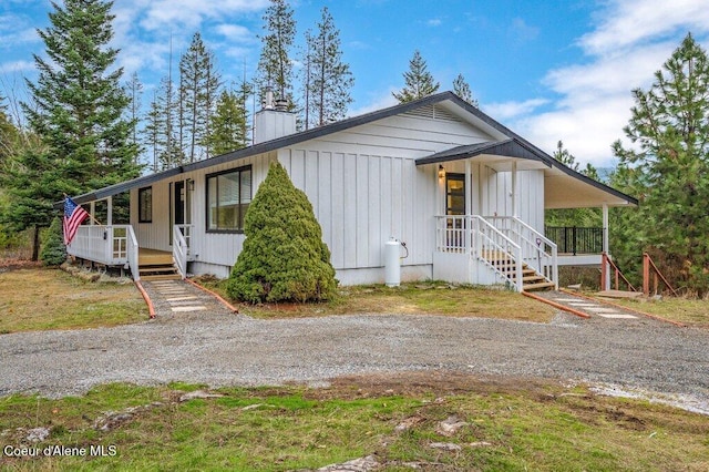 16 Beers Humbird Rd, Sagle, ID 83860 - view of front of house featuring covered porch and a chimney