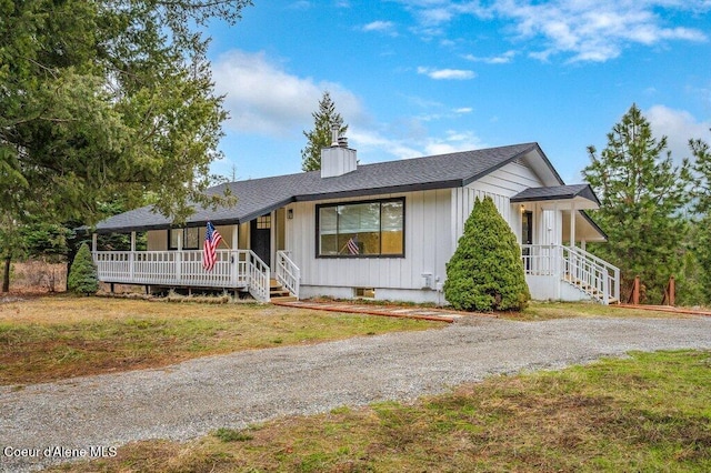 16 Beers Humbird Rd, Sagle, ID 83860 - view of front of home featuring covered porch, a chimney, a front yard, and roof with shingles